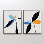 The Minimal Flora Set of 2 features framed abstract floral prints with minimalist plant shapes in black, blue, orange, and light green on a light background—perfect as modern wall decor for a white wall.