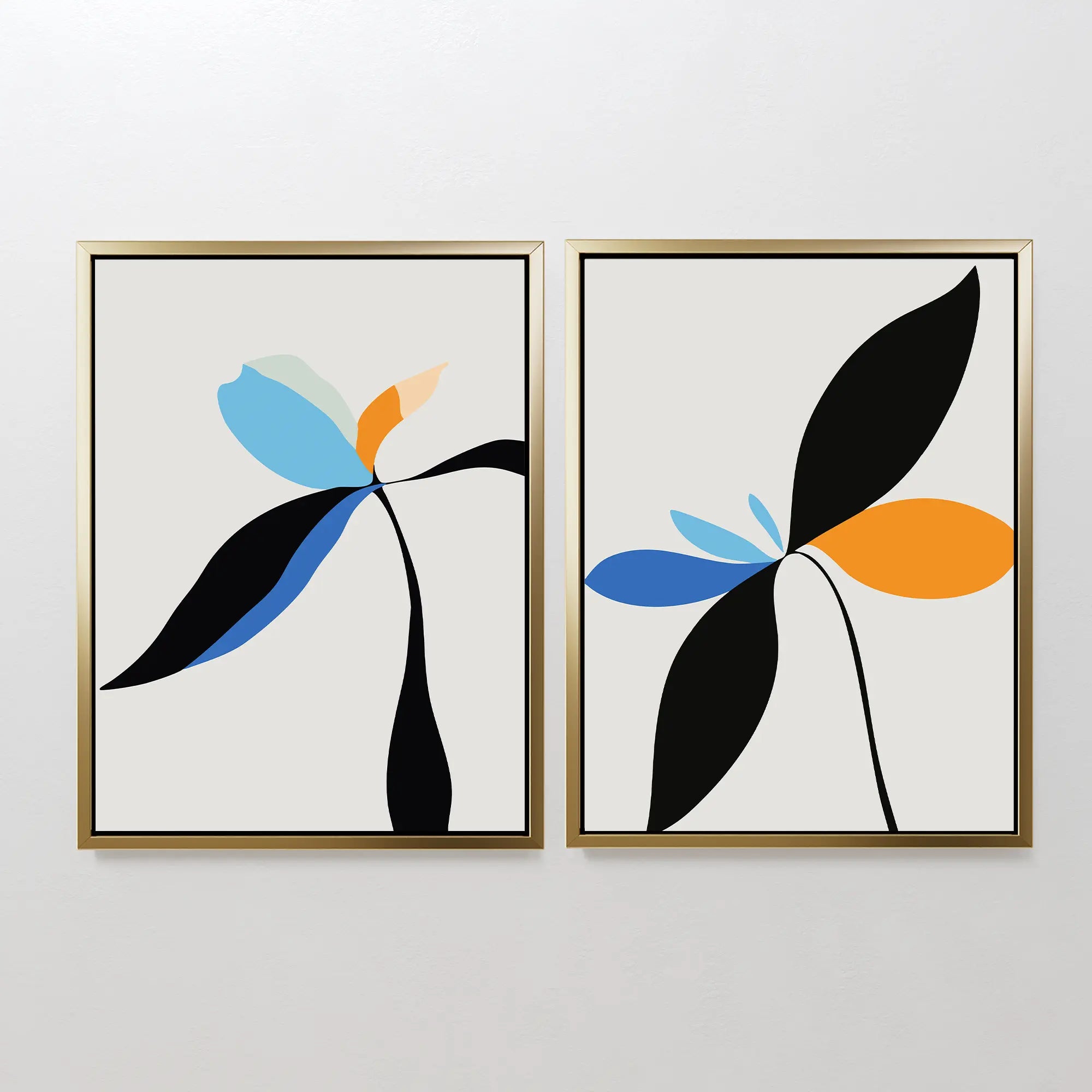 The Minimal Flora Set of 2 features framed abstract floral prints with black stems and blue, orange, and light leaves on white backgrounds, offering striking modern wall decor when displayed side by side.