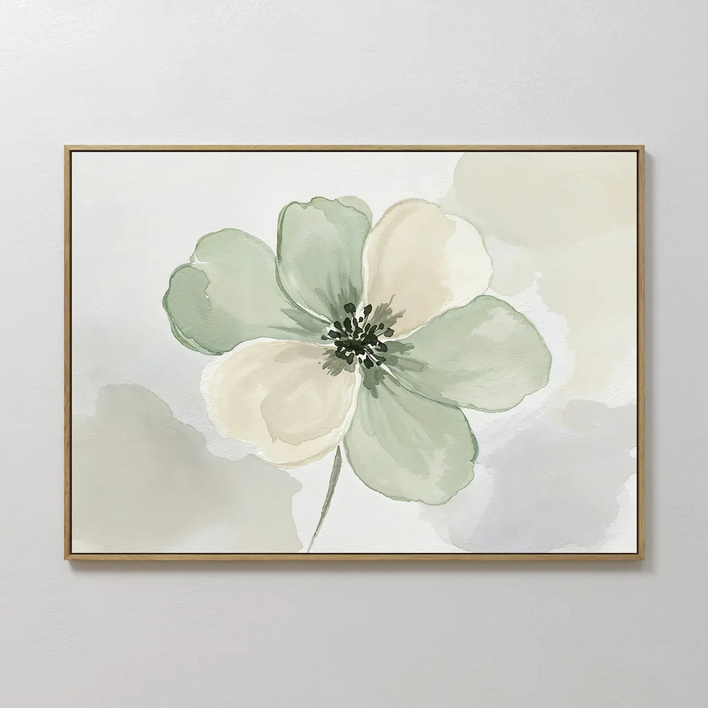 The Mint Meadow Canvas Art is a framed minimalist wall piece featuring a large watercolor flower with soft green and cream petals on a light, abstract background.