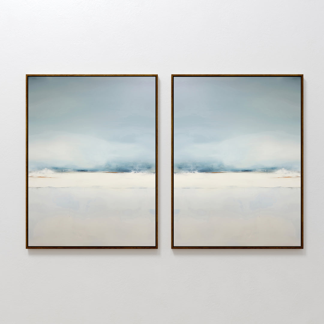 The Misty Morning Set of 2 features minimalist framed abstract paintings in soothing blue, white, and beige tones. Displayed side by side, they evoke the calm beauty of a Nordic park over water, creating a tranquil atmosphere in any space.