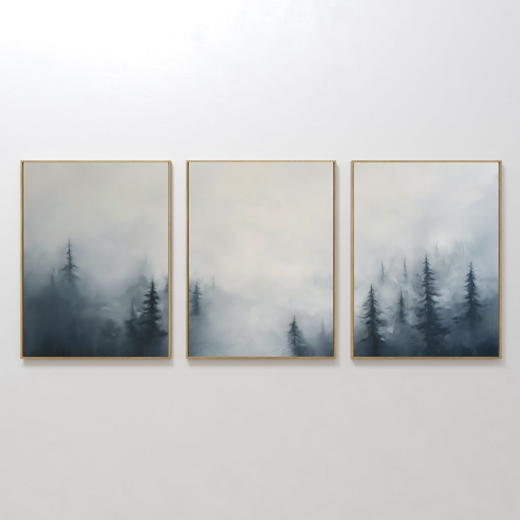 The Misty Pines Set of 3 features framed paintings of a misty Nordic park with tall pine trees fading into a pale sky, creating minimalist and tranquil wall art that brings a cohesive landscape to your space.