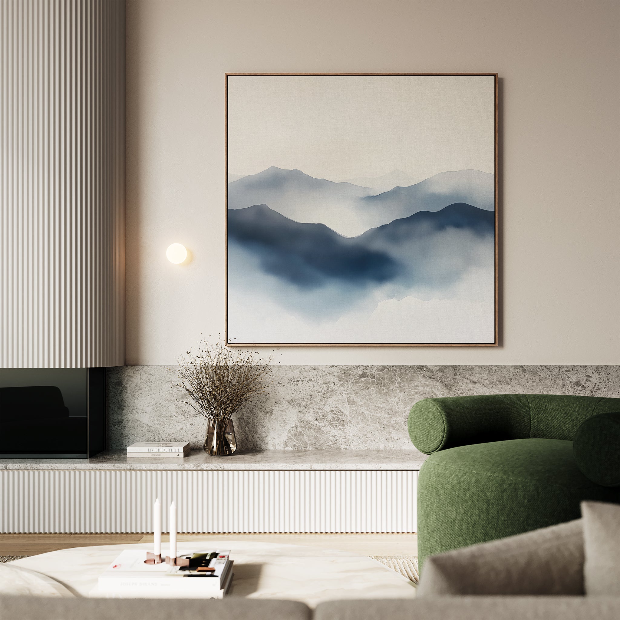 A modern living room features the Misty Ridge Canvas Art on a beige wall, a green upholstered chair, a marble shelf with books and decor, and soft neutral tones throughout the space.