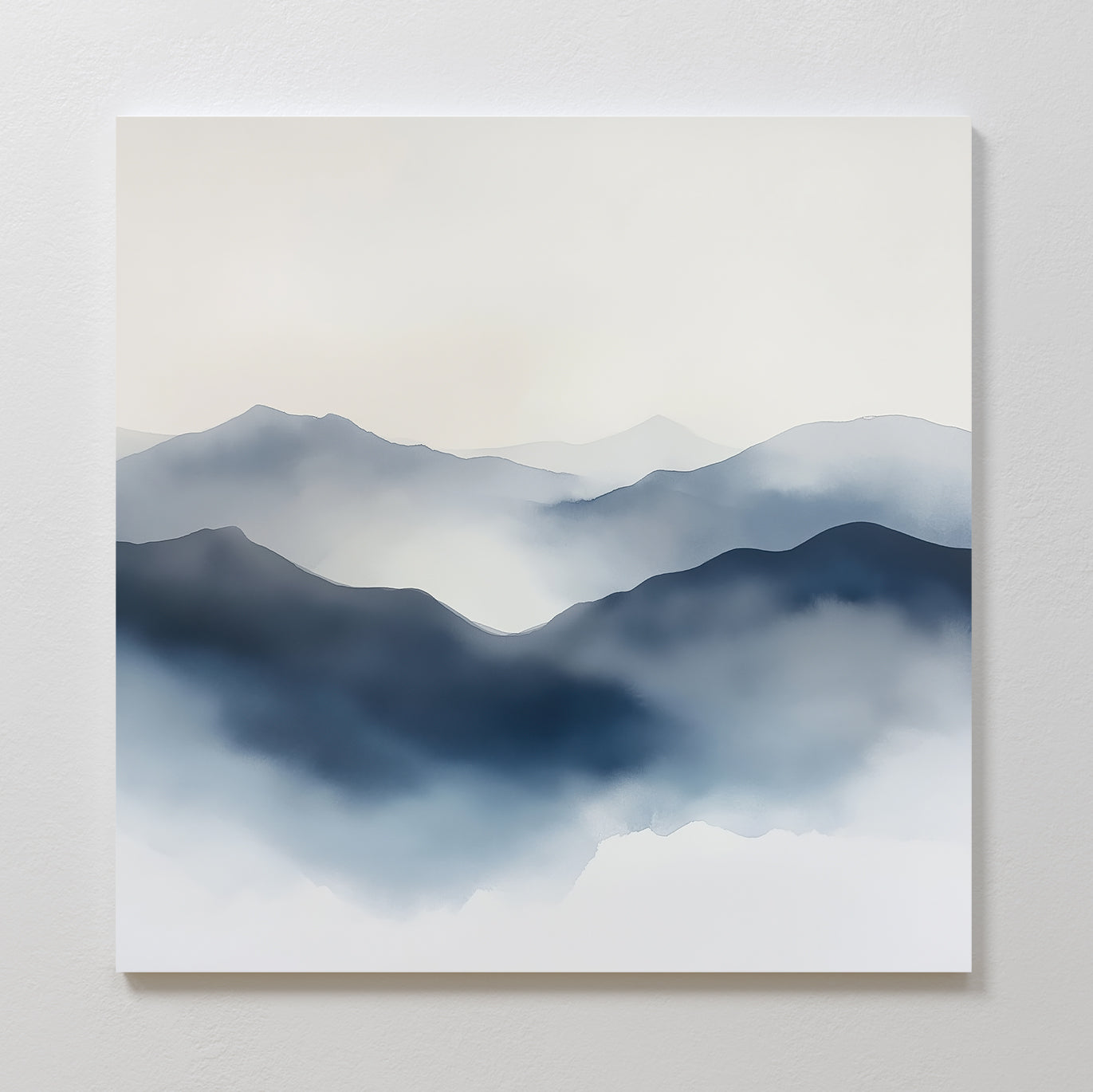 Misty Ridge Canvas Art features a minimalist landscape of blue and gray mountains with soft, misty edges, creating a calm and serene abstract wall art piece perfect for display on a white wall.