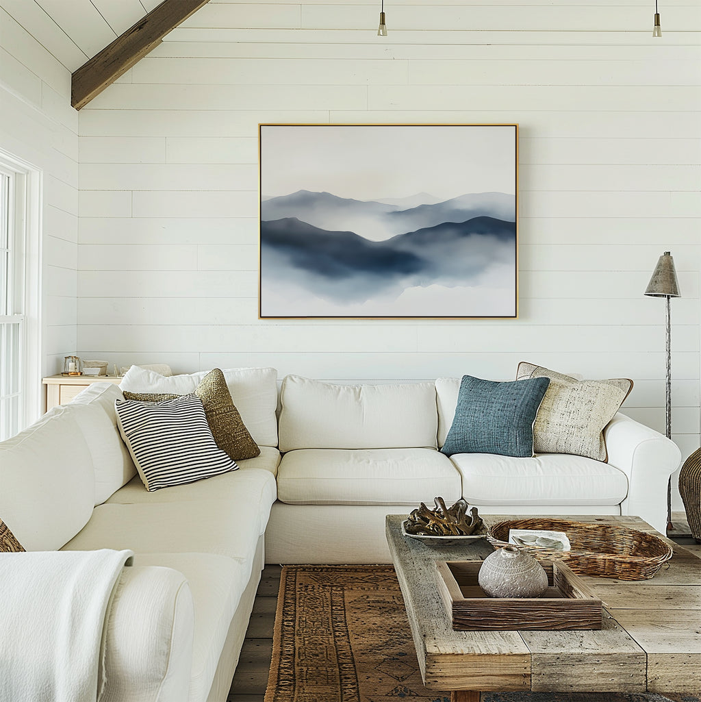 A bright living room with white shiplap walls, a white sectional sofa with pillows, a rustic wood coffee table, and the Misty Ridge Canvas Art – Horizontal hanging above the couch.