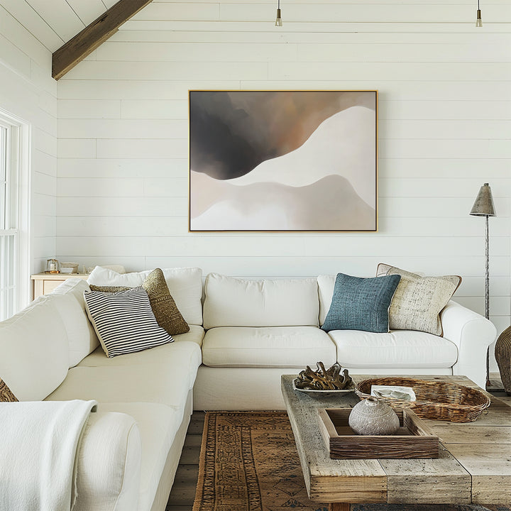 A cozy modern living room with white shiplap walls, a large sectional, rustic coffee table, soft accents, and minimalist wall art—a Misty Silhouette Canvas Art – Horizontal—displayed above the sofa.