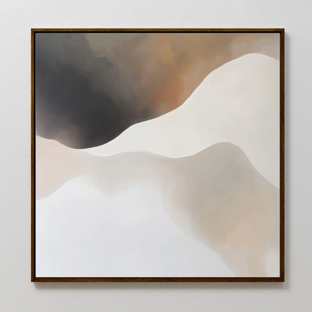 The Misty Silhouette Canvas Art features soft, flowing shapes in beige, white, cream, and brown on canvas, evoking sand dunes or clouds. Framed in dark wood, it’s perfect modern decor for a light gray living room wall.
