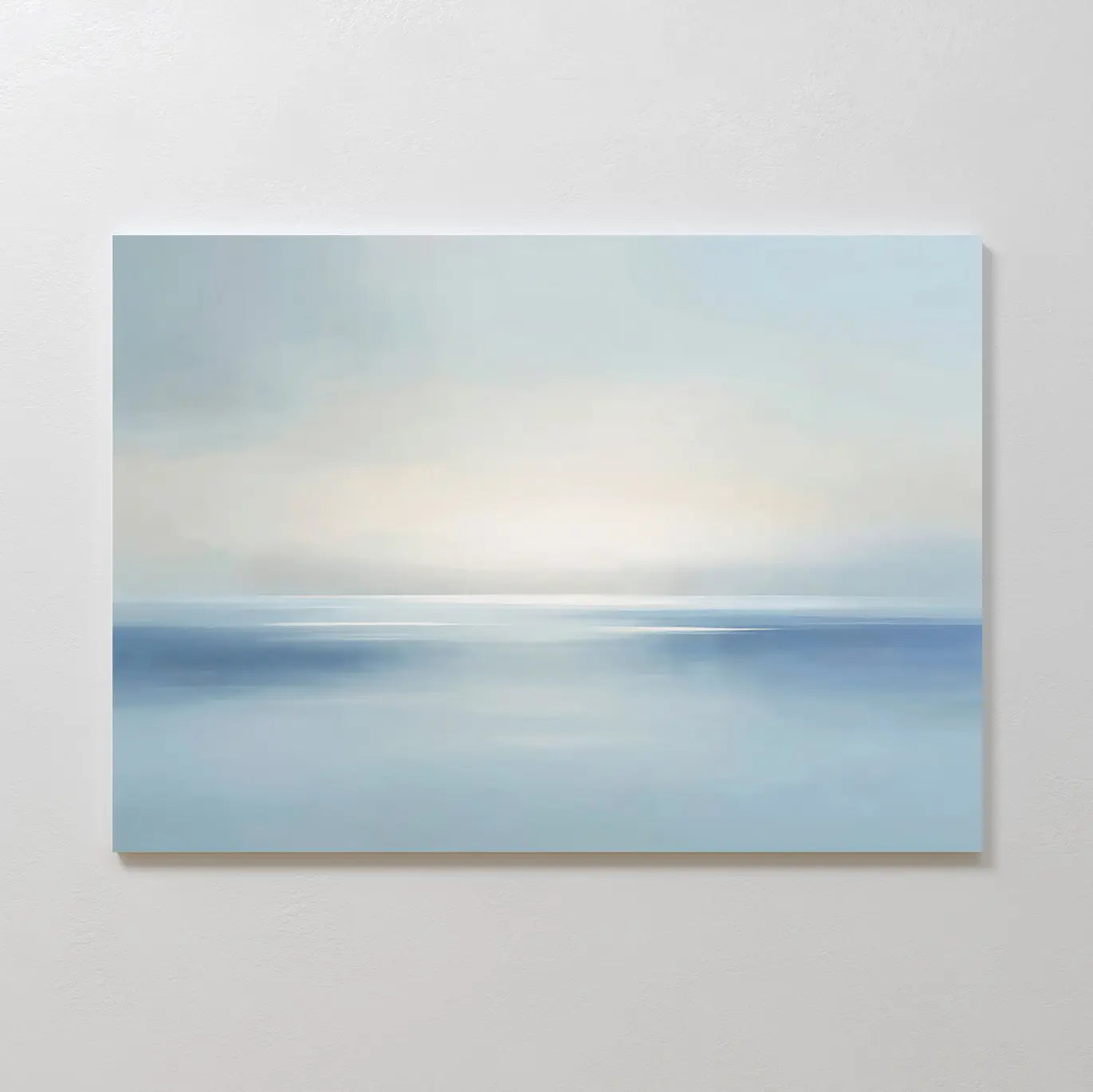 Misty Waters Canvas Art features a minimalist seascape in soft blue and white, with a subtle horizon and gentle light, creating serene wall art that evokes peace and tranquility—ideal for modern wall decor.