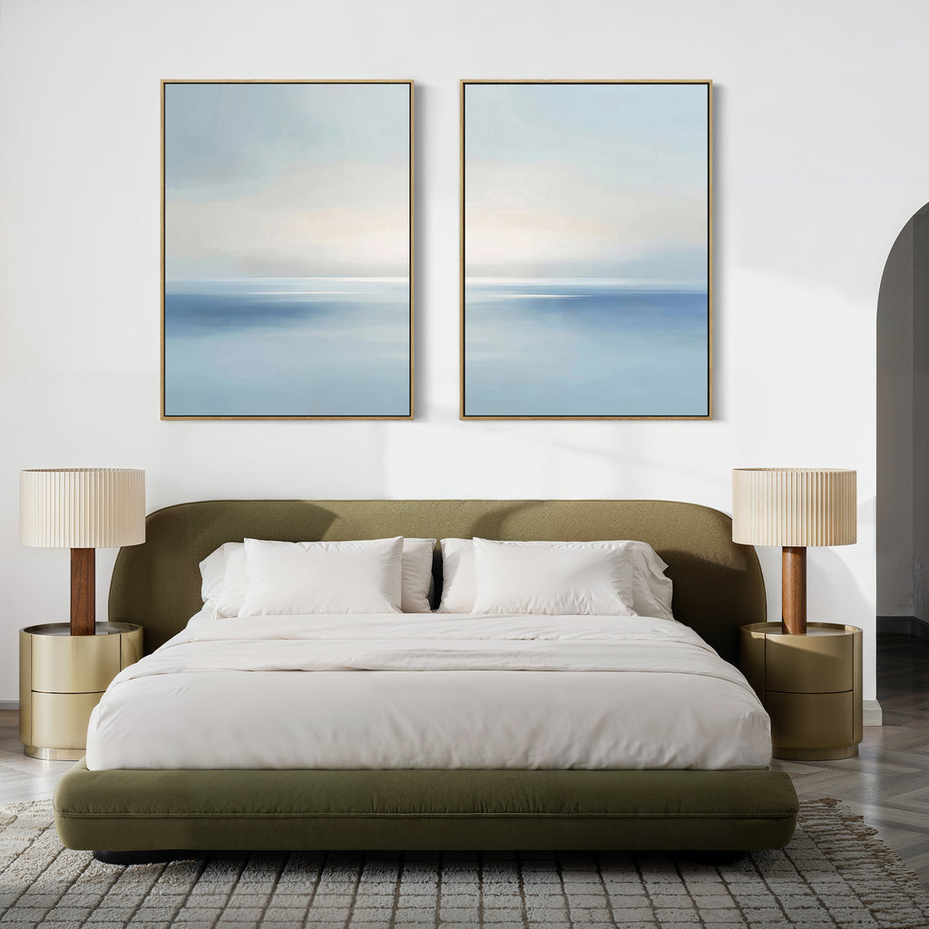 Minimalist bedroom with an olive green bed, white bedding, beige nightstands and lamps, and the Misty Waters Set of 2 serene blue and white artworks hung above the bed on a white wall.