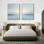 Minimalist bedroom with an olive green bed, white bedding, beige nightstands and lamps, and the Misty Waters Set of 2 serene blue and white artworks hung above the bed on a white wall.