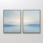 The Misty Waters Set of 2 features framed abstract paintings with soft blue and white tones, creating a serene seascape with a subtle horizon—perfect minimalist wall art for any modern space.