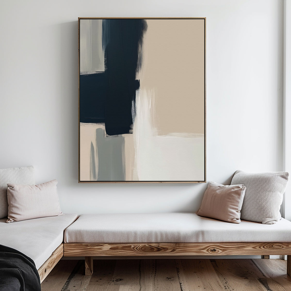 Minimalist living room with light wood furniture, beige cushions, and the Modern Contrast Abstract Canvas Art in navy blue, beige, and white tones displayed on a white wall above the seating area.