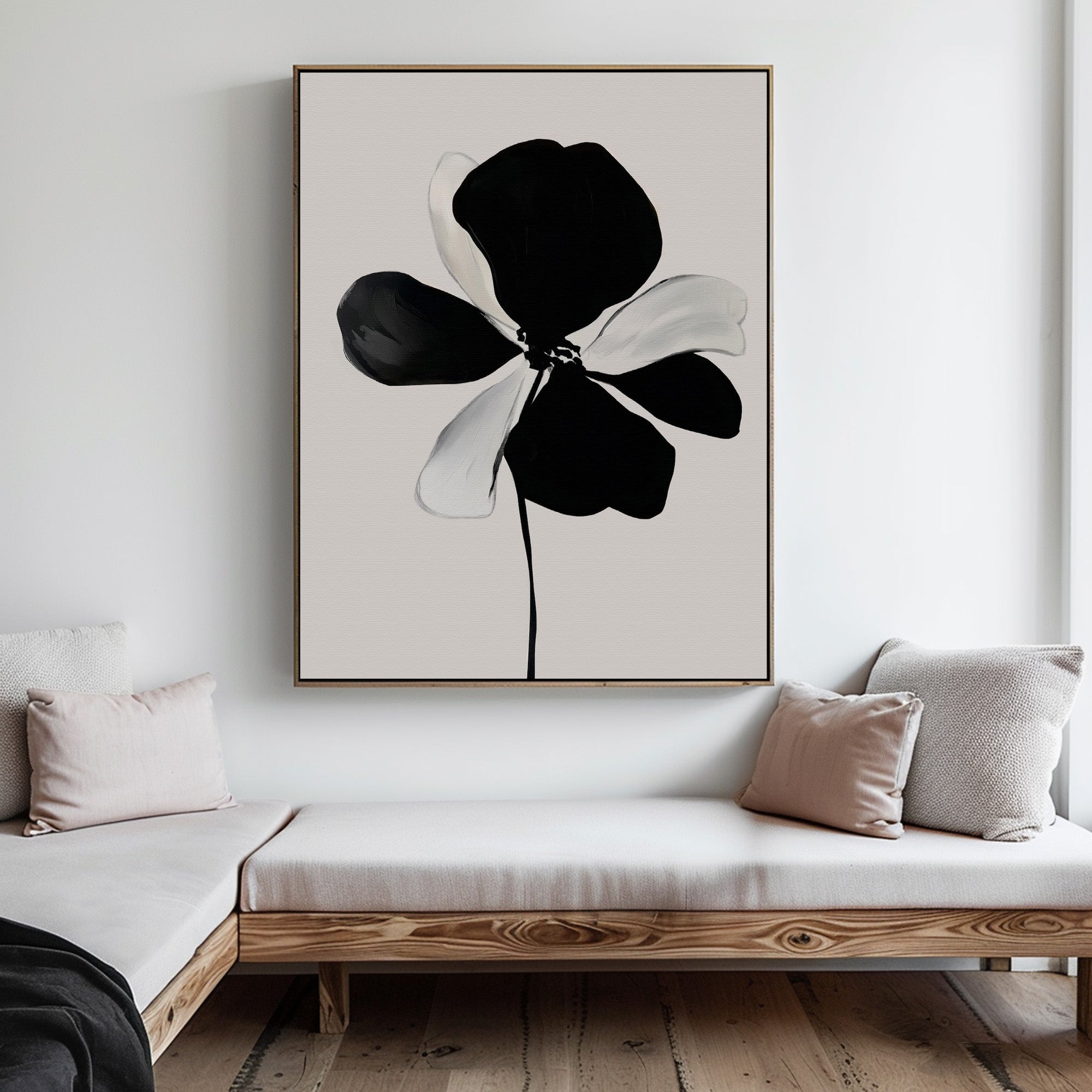 A minimalist living room with a wooden bench, light cushions, and the Monochrome Flora Abstract Canvas Art as striking black and white wall decor on a white wall.