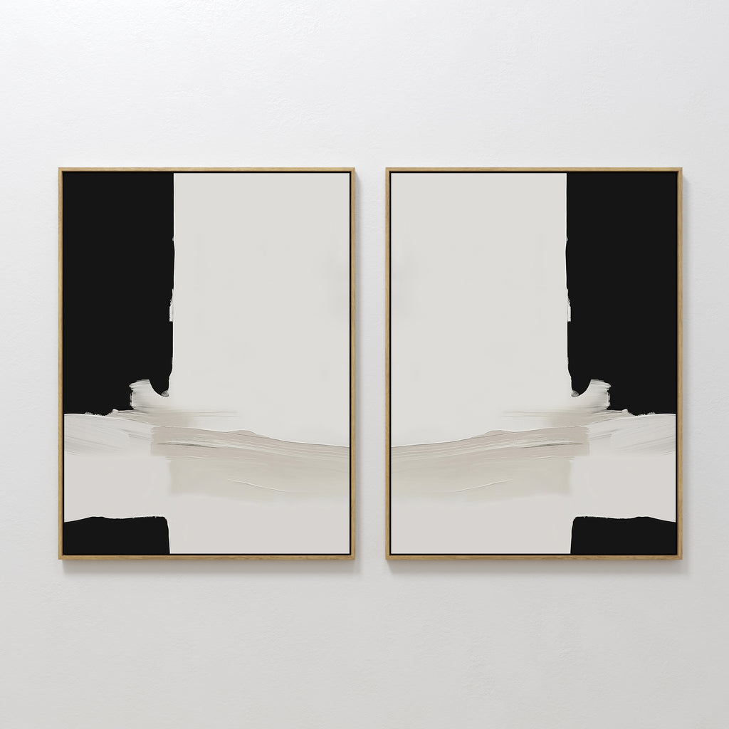 The Monochrome Harmony Set of 2 features bold black and cream framed minimalist wall art, hung side by side for a mirrored, symmetrical effect that adds striking modern style to any white wall.
