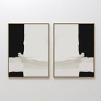 The Monochrome Harmony Set of 2 features bold black and cream framed minimalist wall art, hung side by side for a mirrored, symmetrical effect that adds striking modern style to any white wall.
