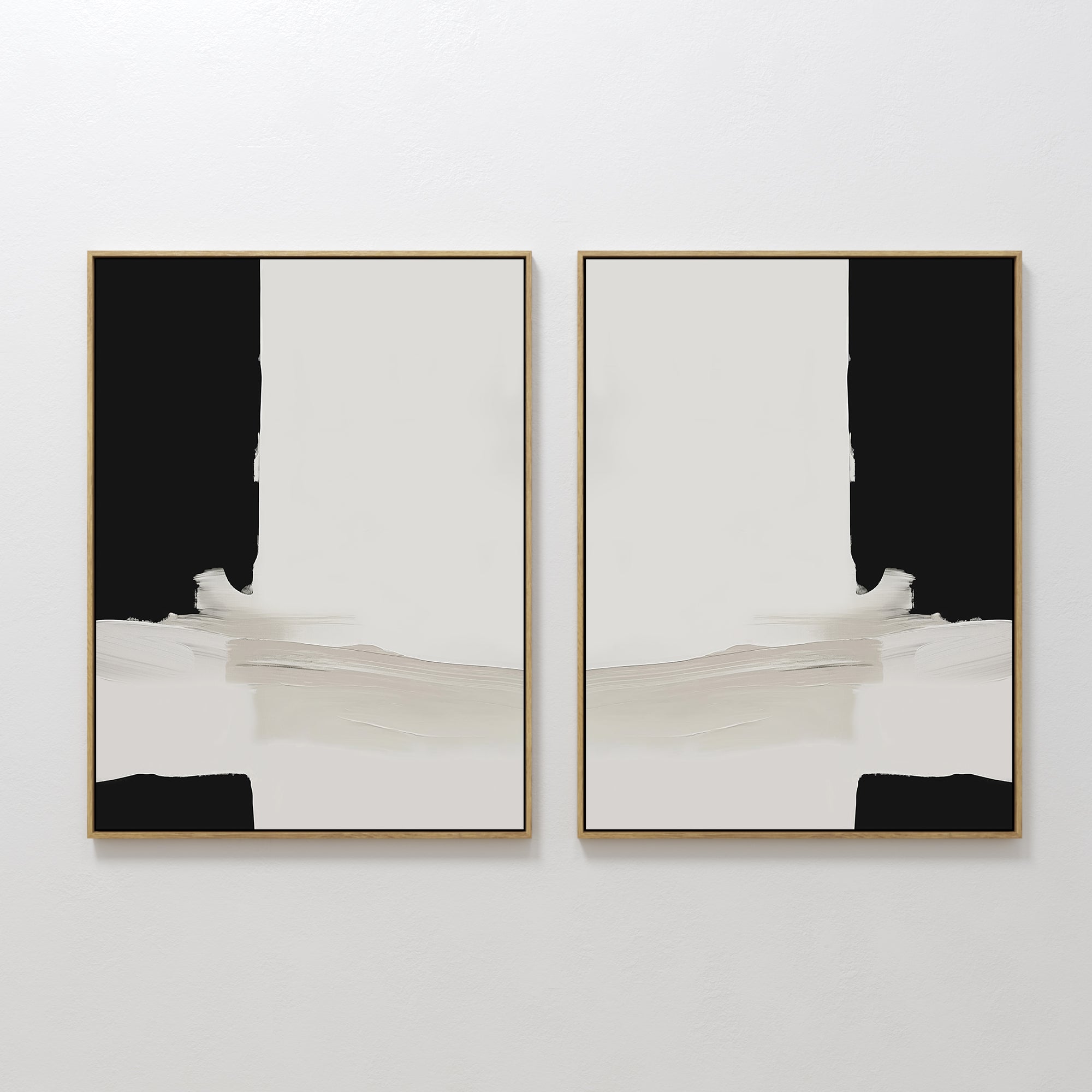 The Monochrome Harmony Set of 2 features bold black and cream framed minimalist wall art, hung side by side for a mirrored, symmetrical effect that adds striking modern style to any white wall.