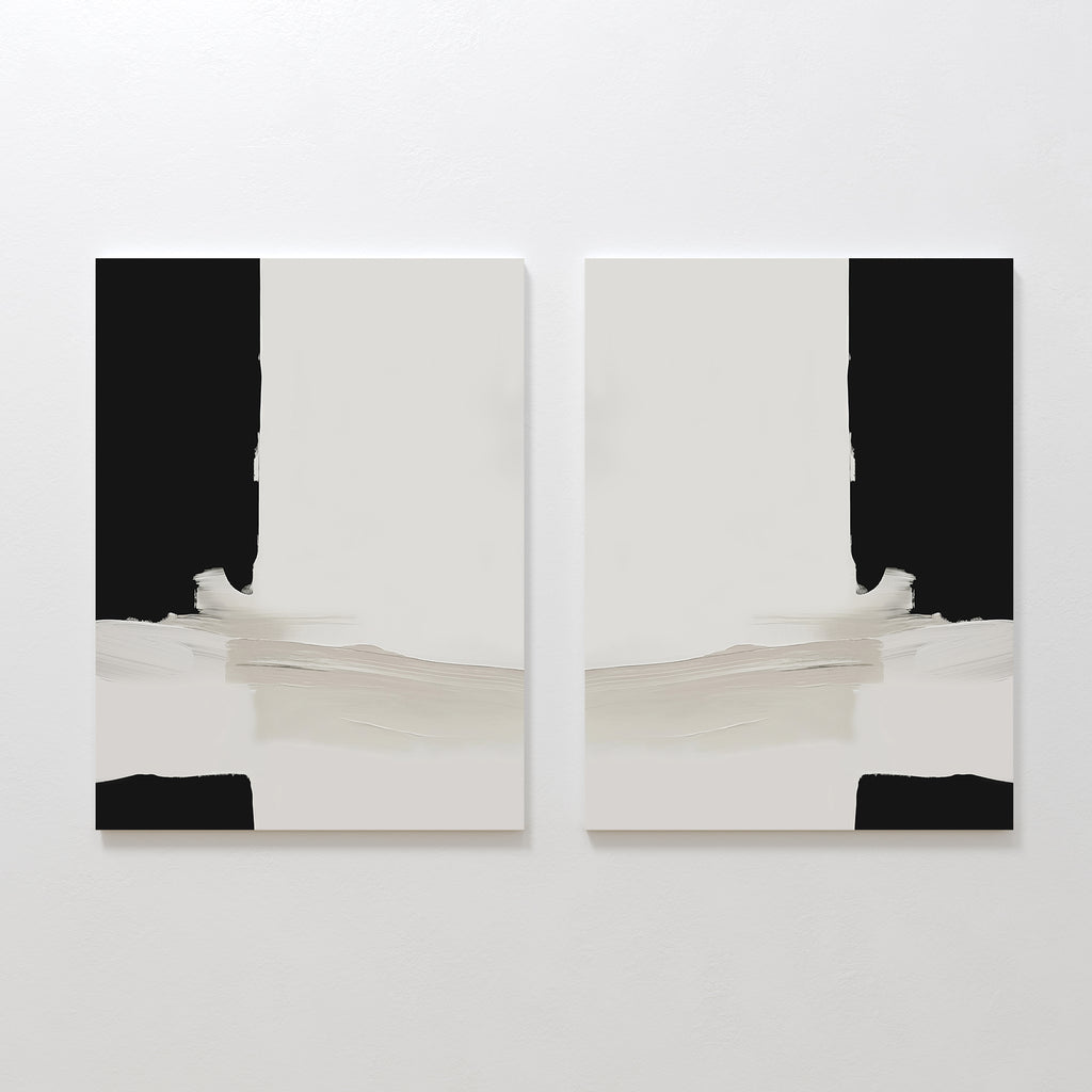 The Monochrome Harmony Set of 2, featuring minimalist wall art with black vertical edges, white centers, and beige horizontal brushstrokes at the bottom, is displayed side by side on a white wall.