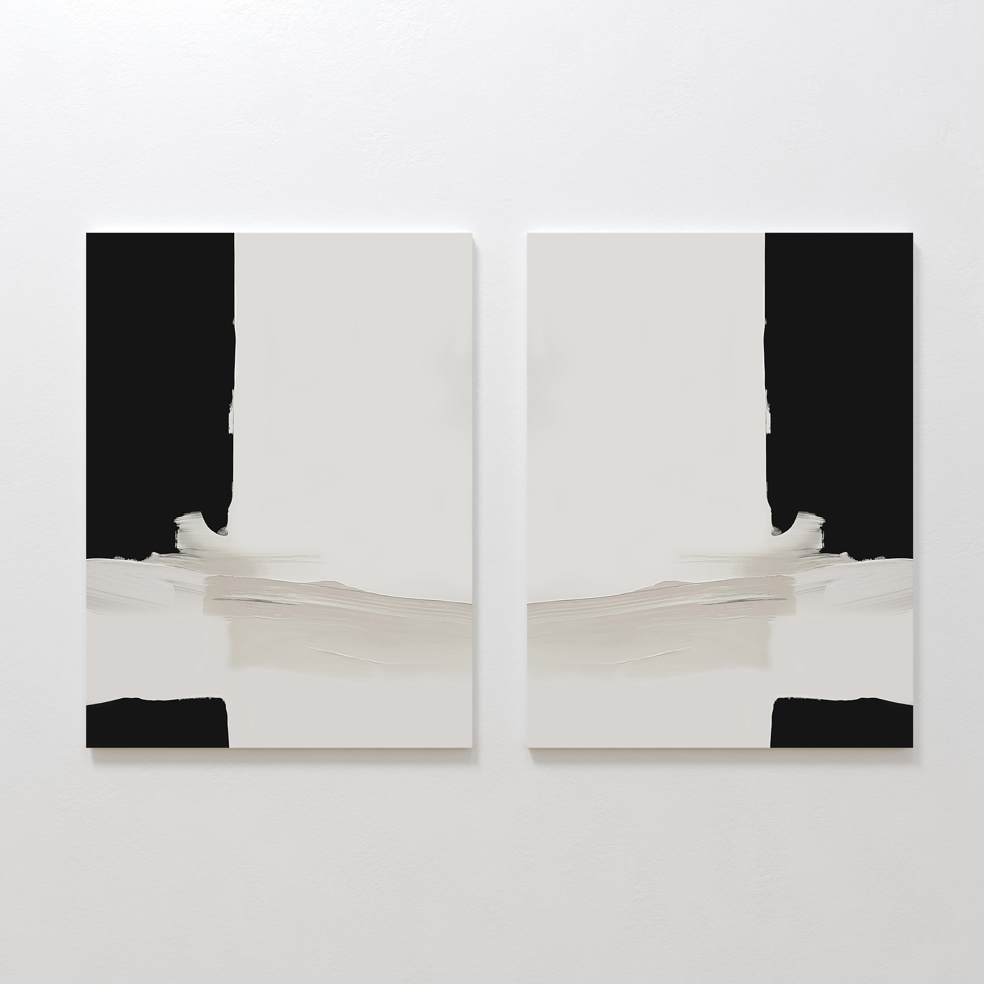 The Monochrome Harmony Set of 2, featuring minimalist wall art with black vertical edges, white centers, and beige horizontal brushstrokes at the bottom, is displayed side by side on a white wall.
