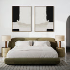 A modern bedroom featuring an olive green upholstered bed, white bedding, beige nightstands with matching lamps, and the Monochrome Harmony Set of 2 black and white wall art pieces above the bed.