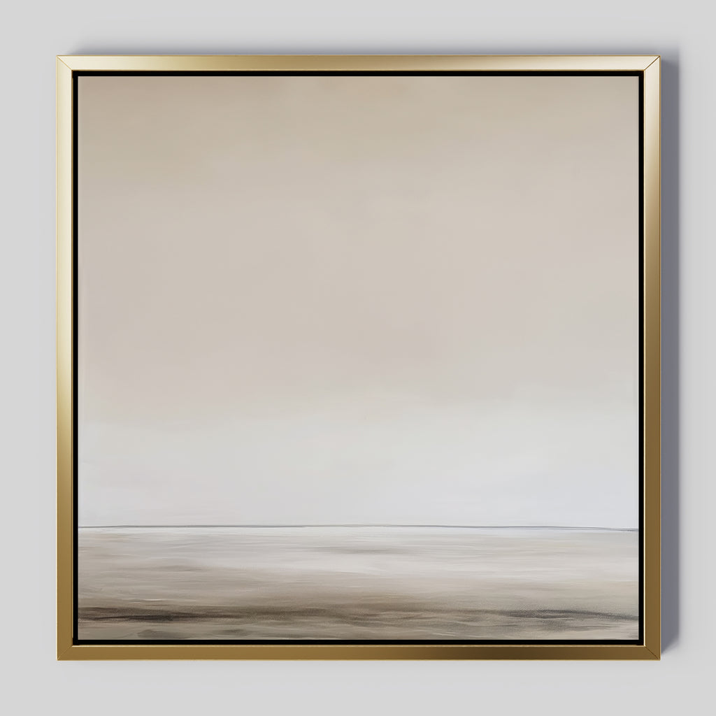The Morning Mist Abstract Canvas Art features a minimalist landscape with a soft horizon and calming beige and gray tones, all framed in metallic gold for a touch of modern elegance.