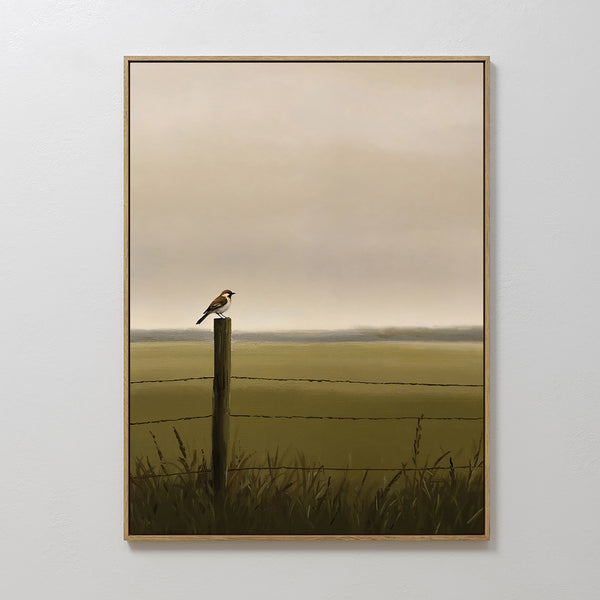Morning Perch Canvas Art depicts a small bird on a fence post amid tall grass and barbed wire in a tranquil field, with a hazy sky creating minimalist wall art ideal for earthy interiors.