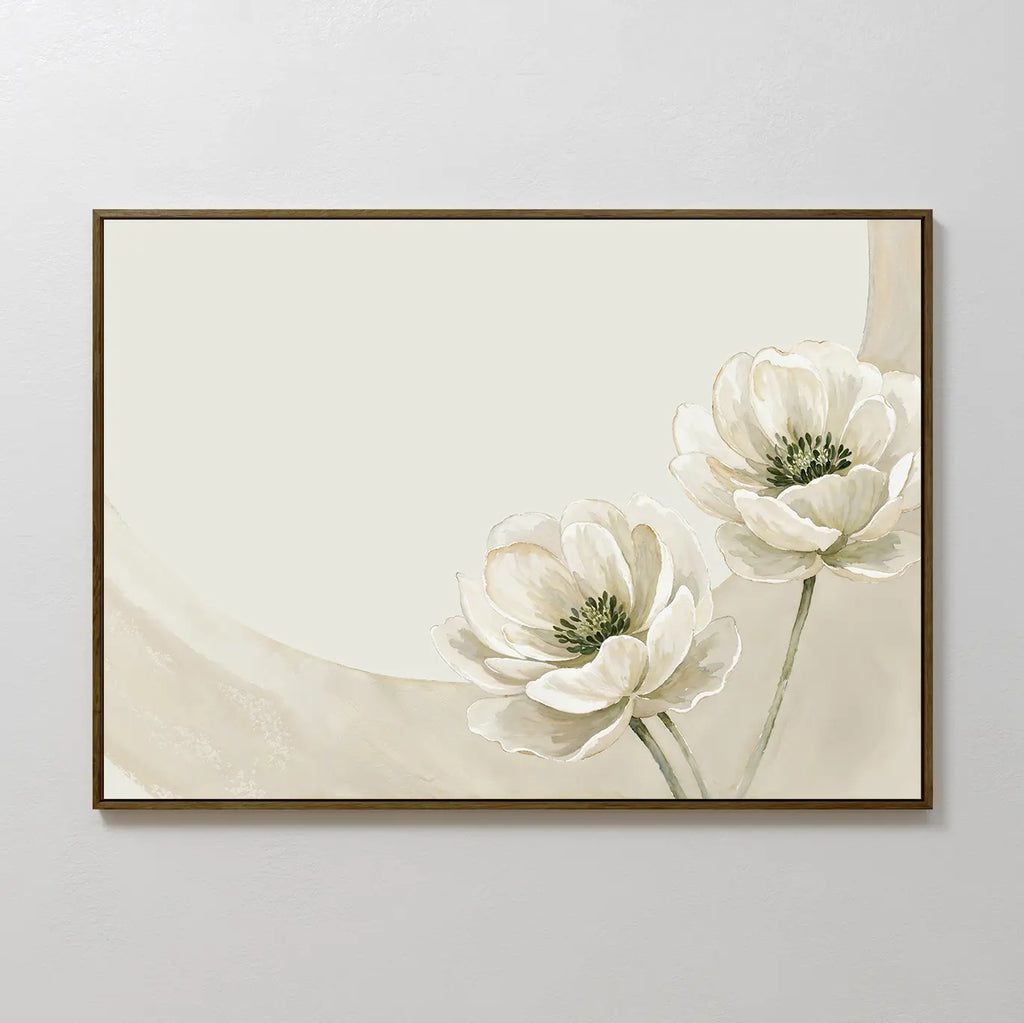 Morning Petals Canvas Art: A framed minimalist wall piece with two white flowers, green centers and stems in the lower right corner on a cream background with beige accents—ideal for bedroom decor.