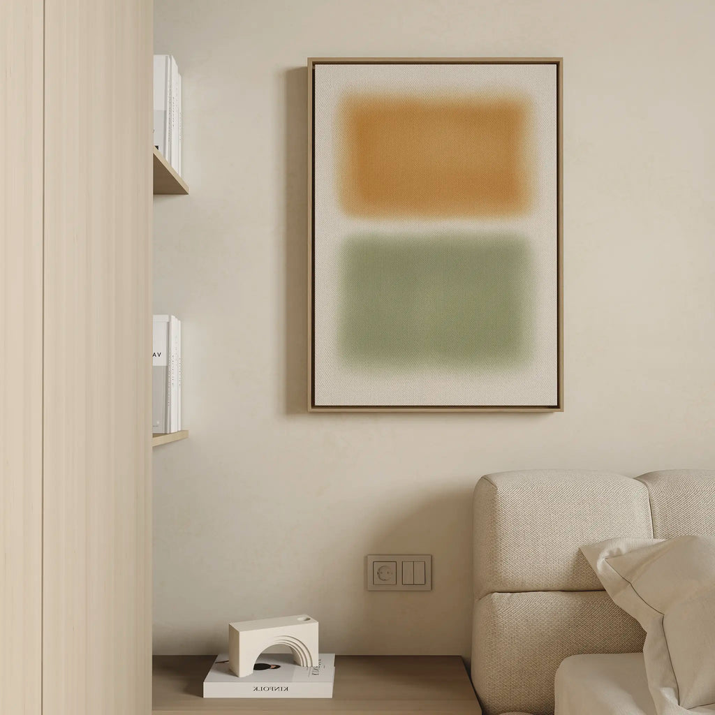 Minimalist living room with a beige sofa, a shelf with white books, and the Morning Whisper Canvas Art—large abstract wall art featuring orange and green rectangles. A small geometric sculpture sits on the wooden floor.
