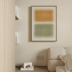 Minimalist living room with a beige sofa, a shelf with white books, and the Morning Whisper Canvas Art—large abstract wall art featuring orange and green rectangles. A small geometric sculpture sits on the wooden floor.