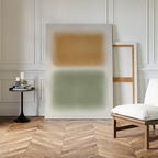 A minimal interior featuring a white wall, chevron wood floor, modern chair, small black round table with candles and books, and the Morning Whisper Canvas Art leaning casually against the minimalist wall.