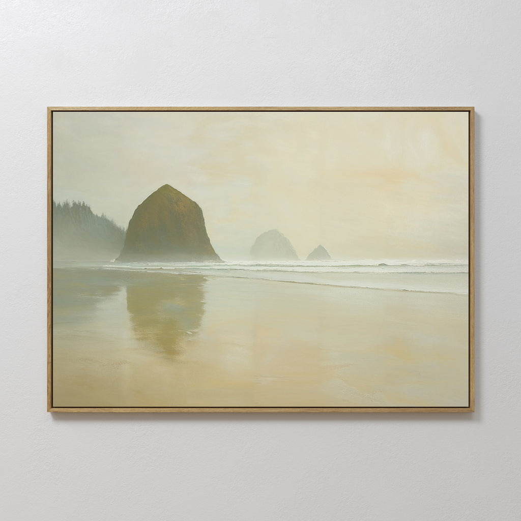 The Morning At Cannon Beach Canvas Art features a misty beach scene with large rock formations, gentle waves, a distant treeline, and an overcast sky, capturing the serene coastal atmosphere.