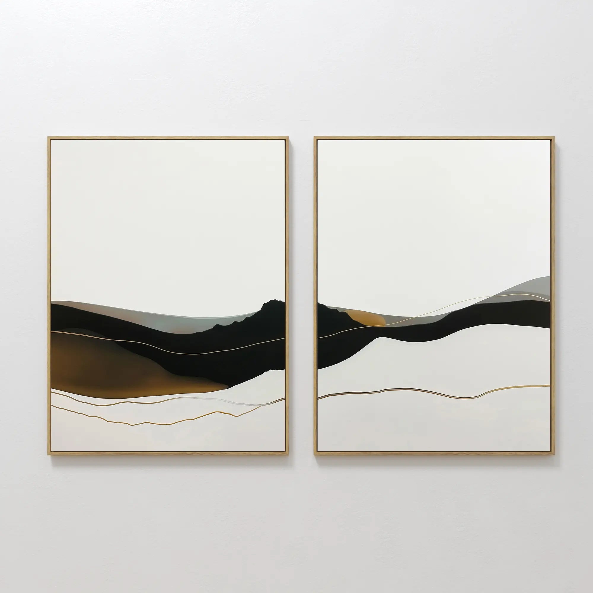 The Mountain Contour Set of 2 features abstract framed artworks with layered black, white, beige, and gold shapes, evoking minimalist mountain landscapes and adding contemporary style to any plain white wall.