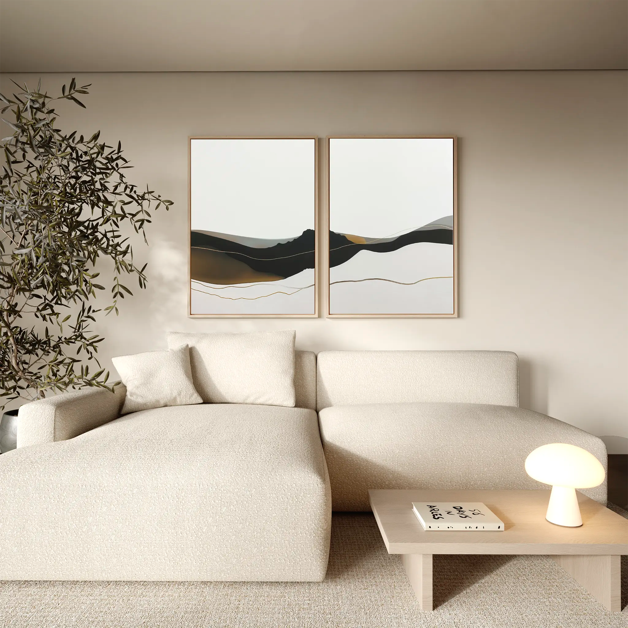 A modern living room with a cream sectional sofa, minimalist wooden coffee table, glowing table lamp, tall leafy plant, and the Mountain Contour Set of 2 abstract prints on the wall. The decor features neutral and earthy tones.