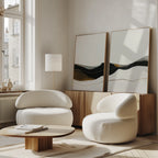 A modern, minimal living room with two white rounded armchairs, a wooden coffee table, and the Mountain Contour Set of 2 prints on the sideboard, complemented by large windows that fill the space with natural light.
