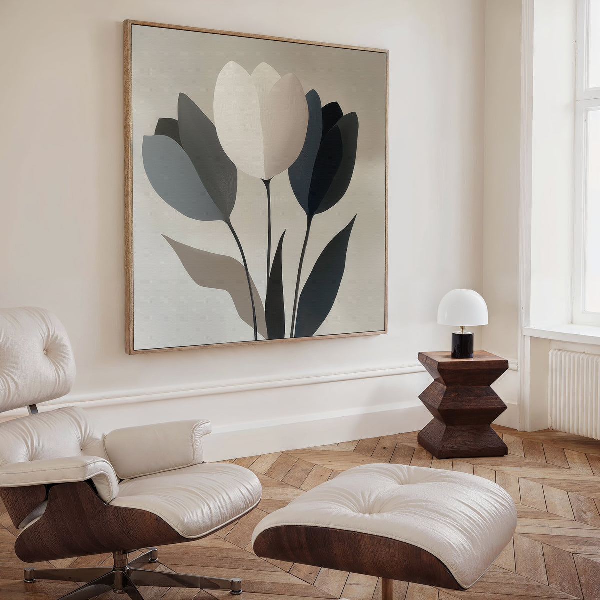 A modern minimalist living room features a cream leather lounge chair and ottoman, geometric wooden side table, white lamp, herringbone wood floor, and the Muted Elegance Canvas Art as a sophisticated focal point above.