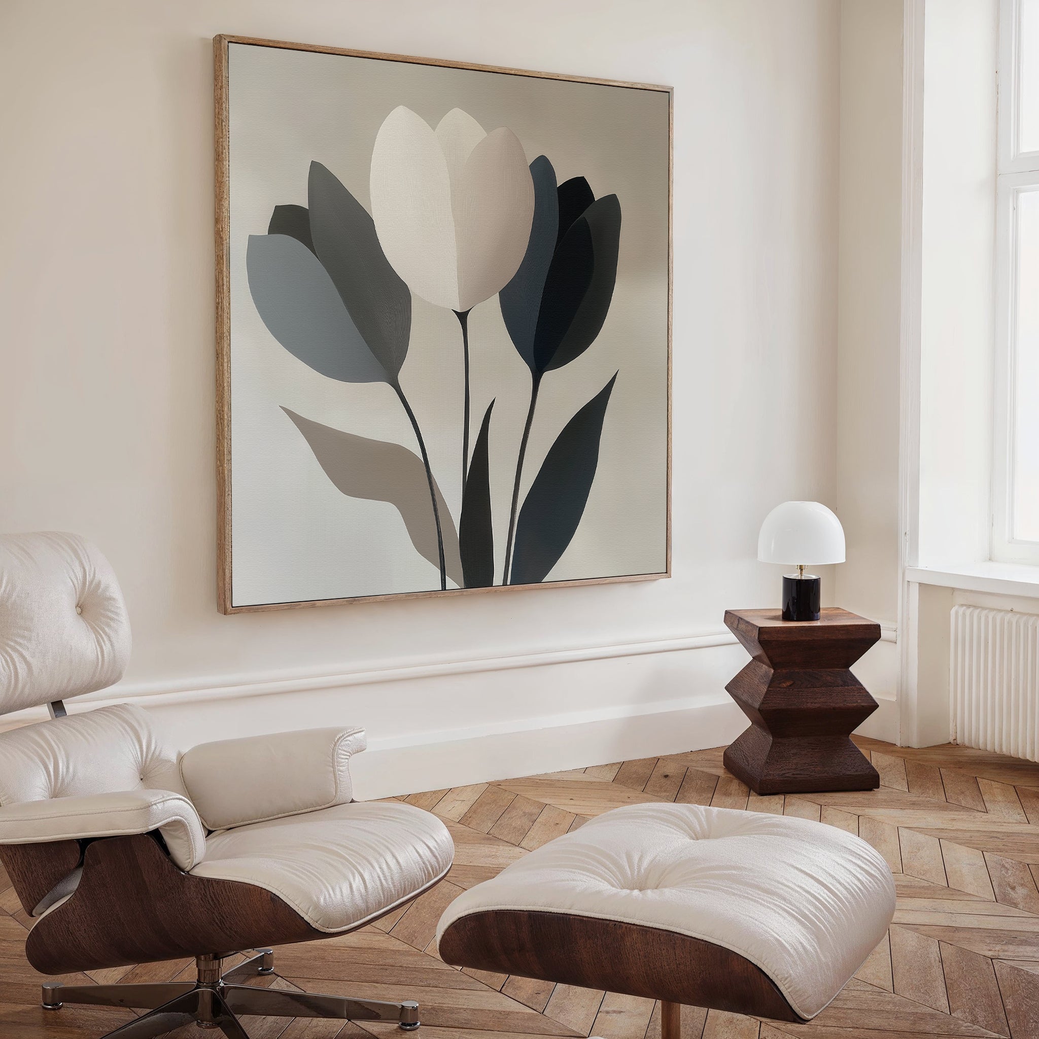 A modern minimalist living room features a cream leather lounge chair and ottoman, geometric wooden side table, white lamp, herringbone wood floor, and the Muted Elegance Canvas Art as a sophisticated focal point above.