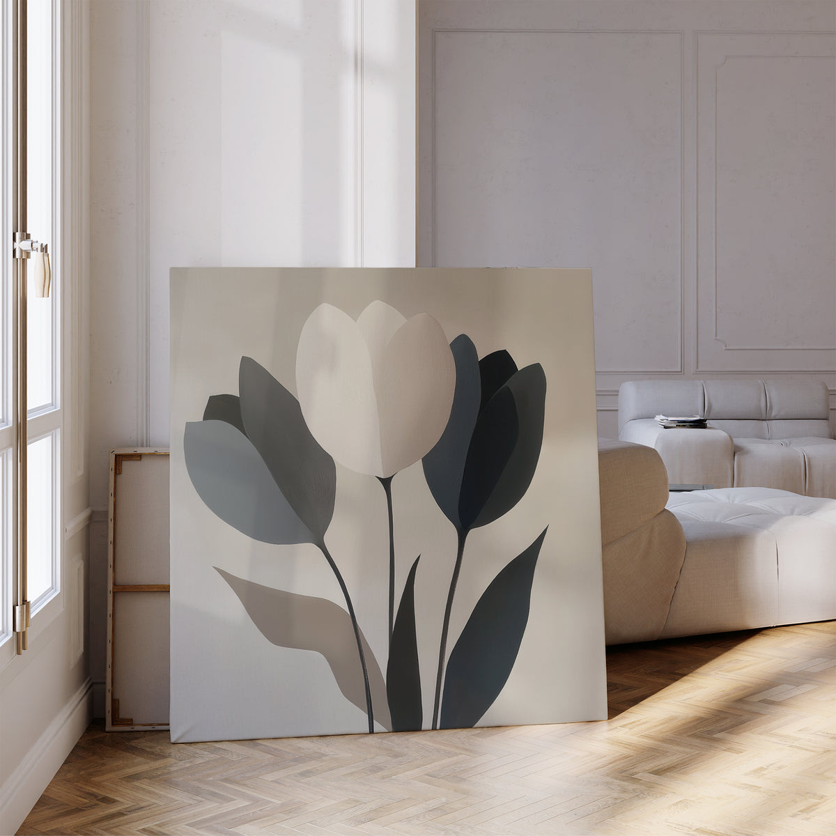 The Muted Elegance Canvas Art, featuring minimalist abstract tulips in soft tones, leans against the wall in a bright living room with wooden floors and a cream sofa.