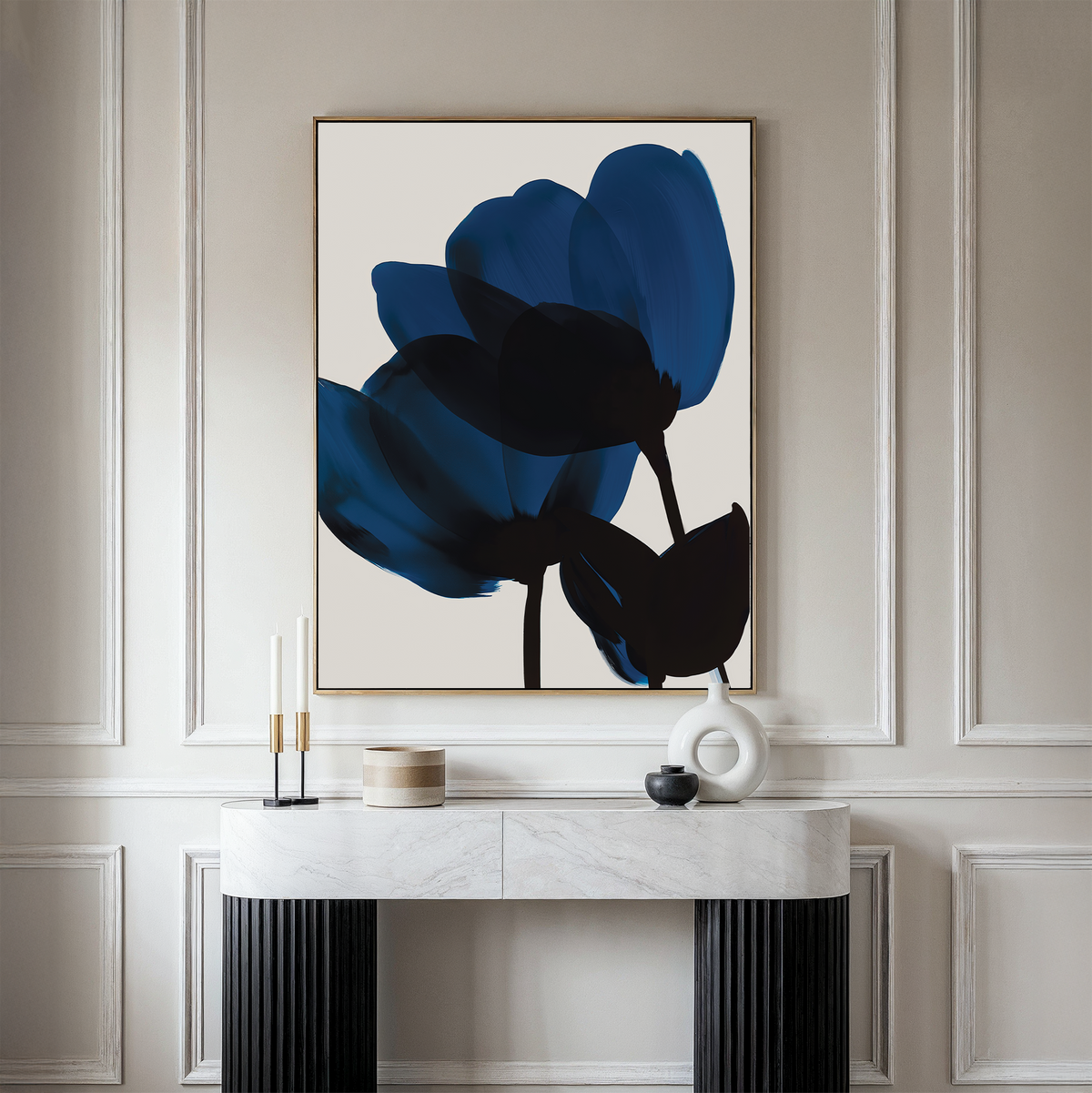 A minimalist room features a marble console table, decorative accents, and the Bloom Abstract Canvas Art—large and dark blue floral—hanging above. Light-paneled walls complete this stylish living room decor.