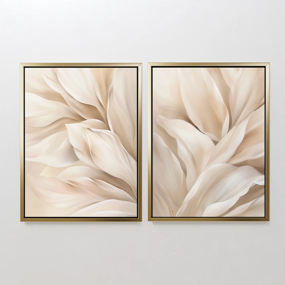 The Natural Texture Set of 2 features framed abstract paintings with soft cream and beige shapes, resembling petals or leaves, creating elegant neutral wall art when displayed side by side on a light-colored wall.