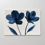 The Navy Flora Canvas Art showcases a minimalist floral print with two large blue flowers and long stems on a neutral background—ideal as navy wall art for large wall decor.