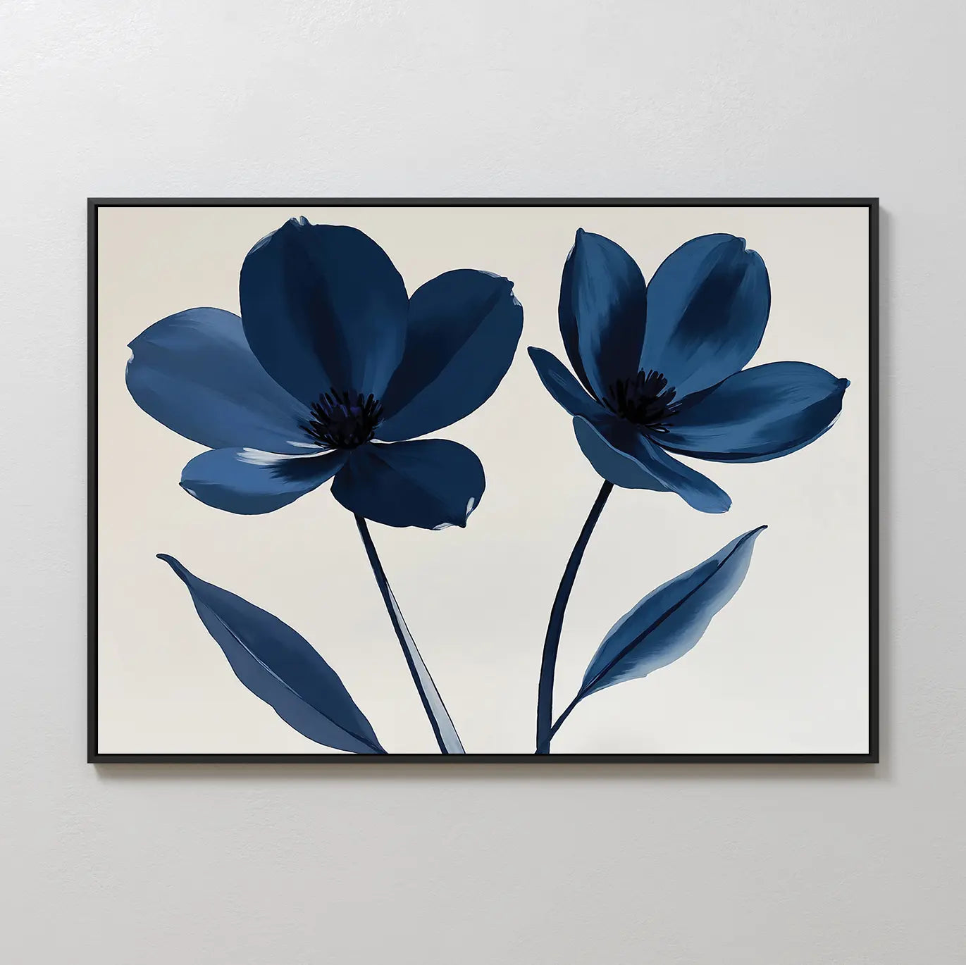 Navy Flora Canvas Art features two large blue flowers with dark centers and slender stems on a light beige background, framed in a slim black frame—ideal as eye-catching wall decor for a modern space.