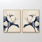 The Navy Magnolia Set of 2 features framed abstract white magnolia flowers with dark blue leaves on light beige backgrounds, creating striking modern floral wall art perfect for any room.