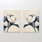 The Navy Magnolia Set of 2 features minimalist canvases with abstract white magnolia flowers and dark blue leaves on a light beige background, creating elegant modern floral wall art.
