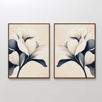 The Navy Magnolia Set of 2 features framed prints of abstract white magnolia flowers with dark blue leaves on light beige backgrounds, creating modern, nearly identical floral wall art for stylish side-by-side display.
