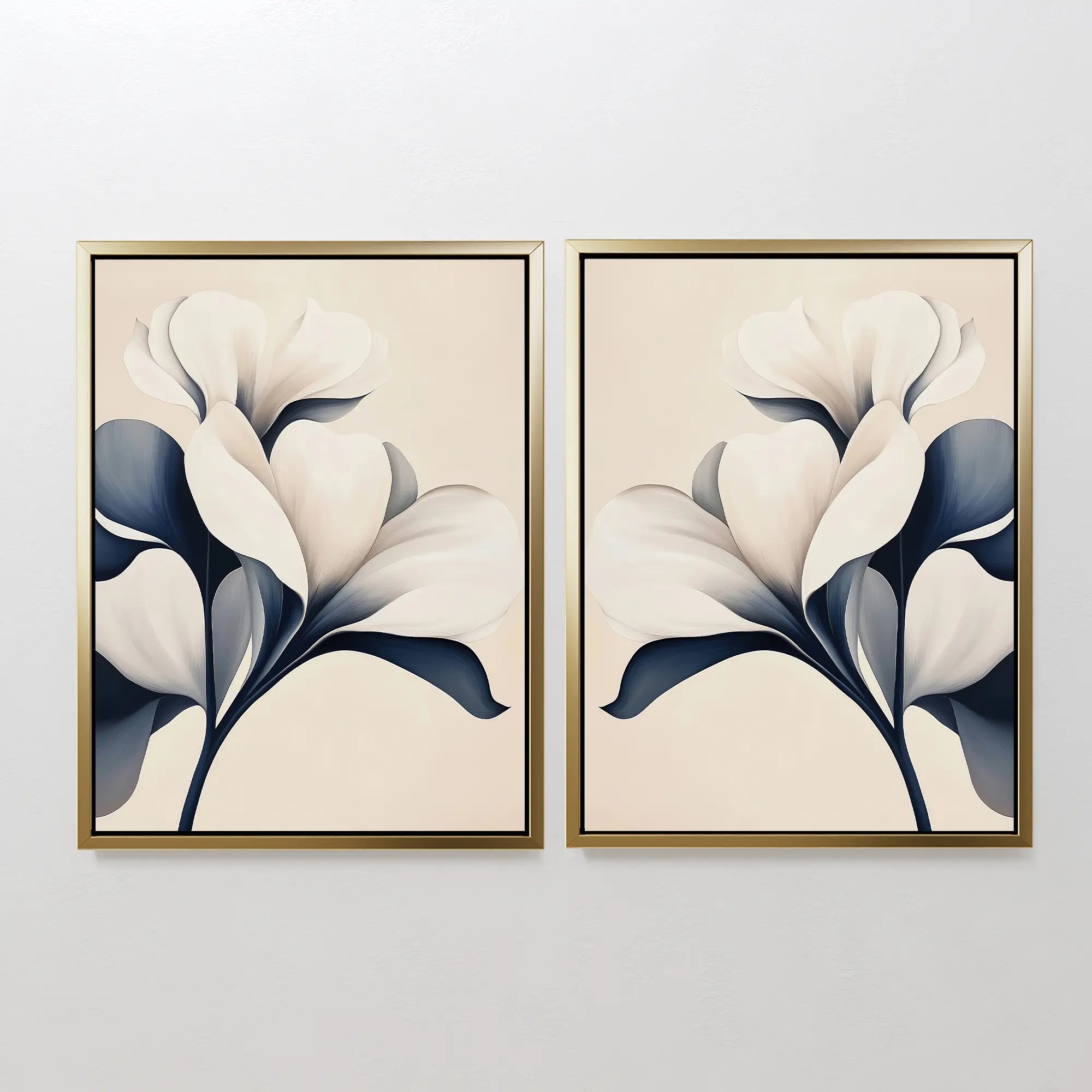 The Navy Magnolia Set of 2 features framed prints of abstract white flowers with dark leaves on a light beige background, ideal as modern wall decor and perfect for hanging side by side on any plain white wall.