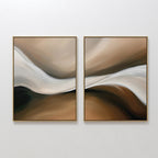 The Neutral Landscape River Set of 2 features abstract wall art with fluid, wavy shapes in beige, brown, cream, and black, framed in gold. These minimalist pieces add movement and a modern touch, perfect for neutral living room decor.