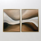 The Neutral Landscape River Set of 2 features abstract paintings with smooth waves in beige, brown, white, and black, gold-framed and hung side by side. This minimalist wall art adds movement and harmony to your living room.