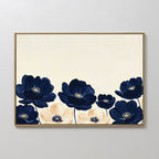 The Nightshade Canvas Art – Horizontal features large navy blue and cream flowers with dark centers on a light beige background, beautifully framed and displayed on a white wall.