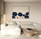 A modern living room with a beige sectional, light wood coffee table, floor lamp, and the Nightshade Canvas Art – Horizontal featuring blue and cream florals. Neutral tones and minimal decor create a calm ambiance.