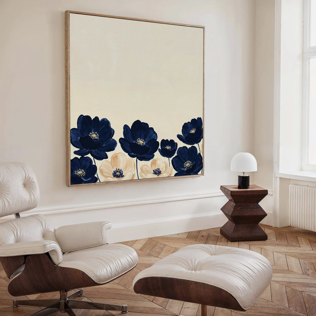 A modern living room with a white lounge chair and ottoman, a wooden side table with a white lamp, and the Nightshade Canvas Art hanging above light wood herringbone flooring.
