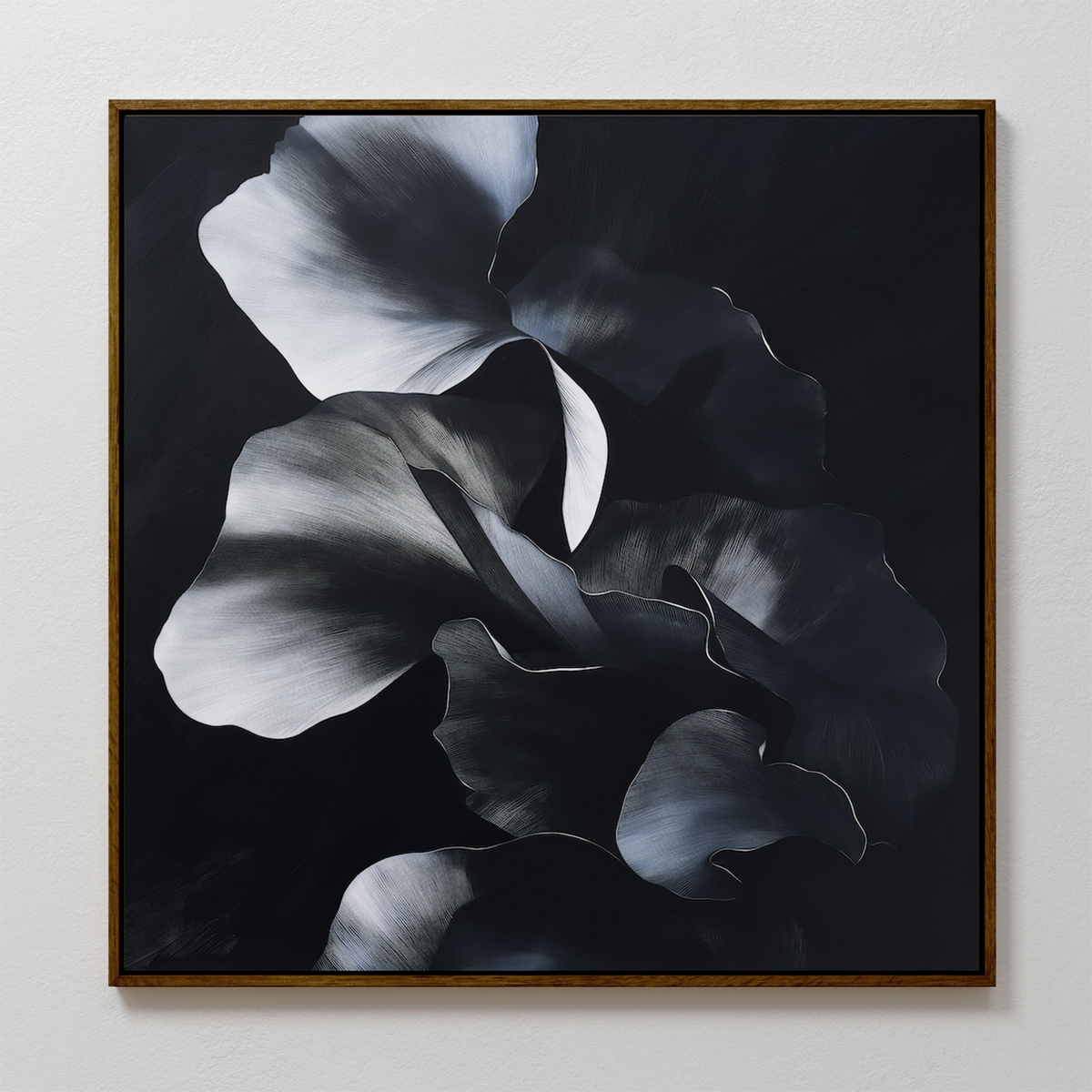 Nocturnal Bloom Abstract Canvas Art is a framed wall piece, showcasing bold black, grey, and white petals with dramatic brushstrokes. This modern art adds striking contrast and presence to any textured white wall.