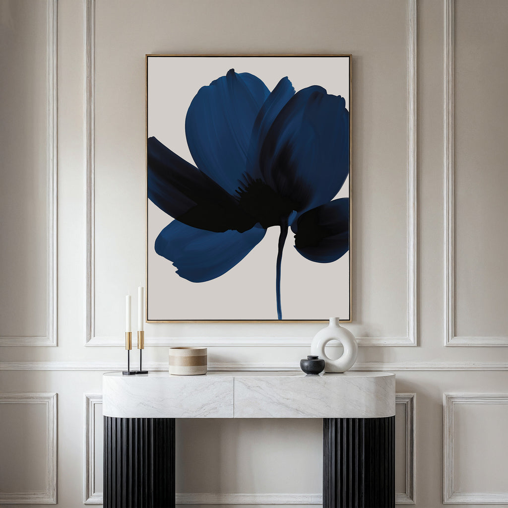A minimalist room with a modern console table, decorative objects, and the Nocturne Blossom Canvas Art—a large framed piece featuring a blue abstract flower above the table—perfect for stylish living room decor.